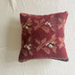 Decorative pillow with a floral pattern deep red