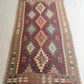Woven rug with geometric pattern on a white floor