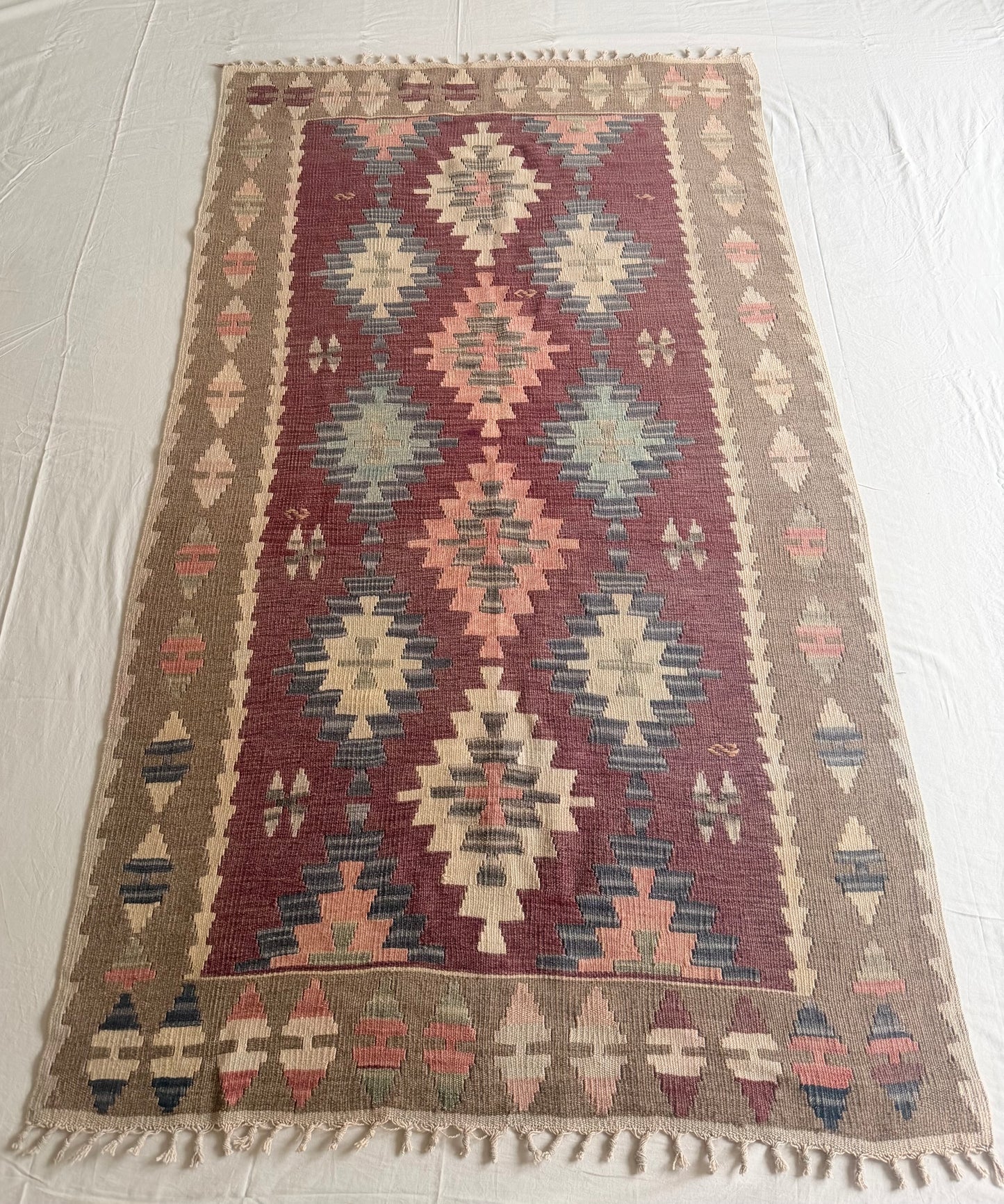Woven rug with geometric pattern on a white floor