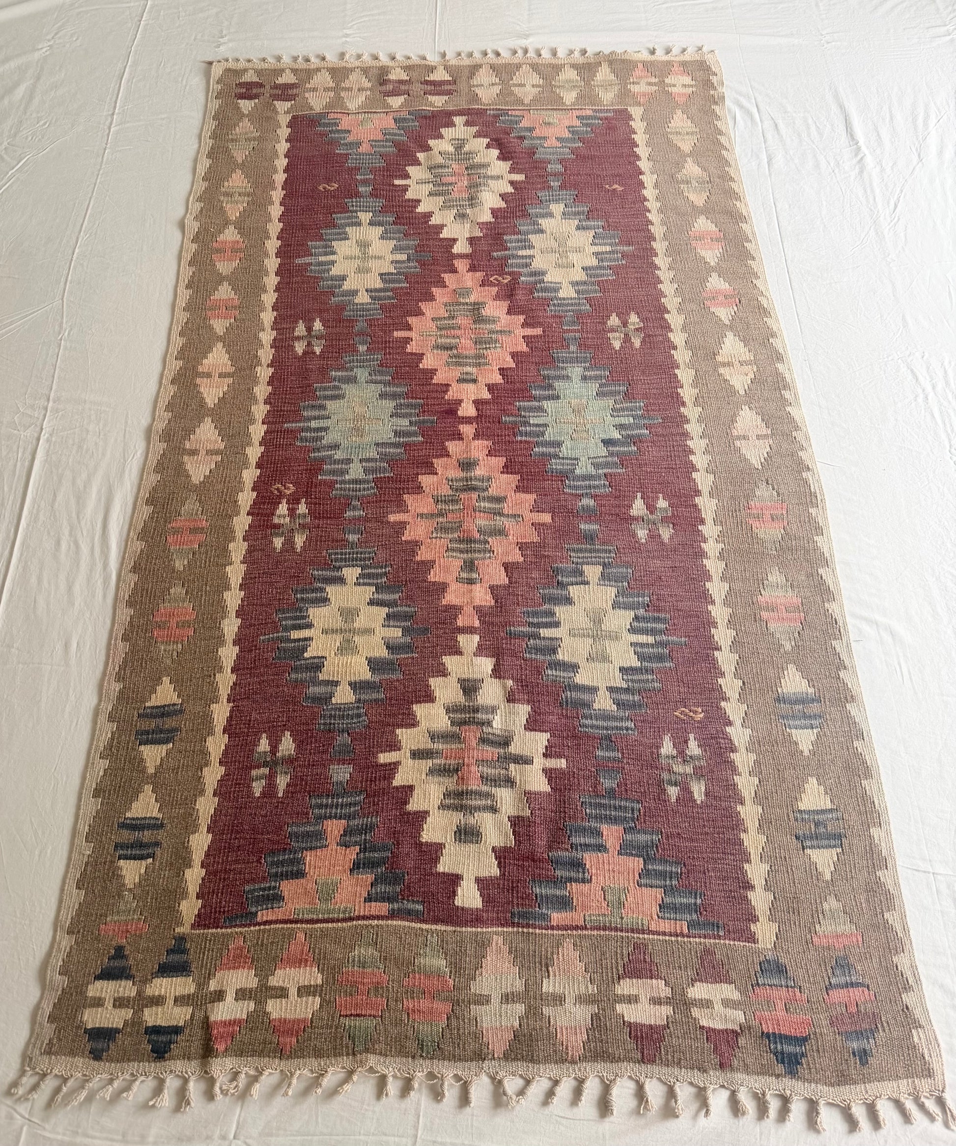 Woven rug with geometric pattern on a white floor