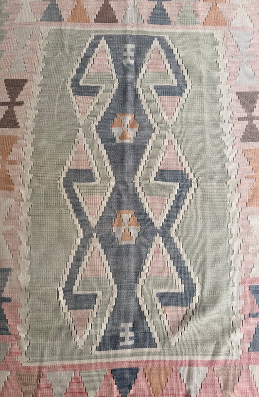 Woven textile with geometric pattern on a plain background