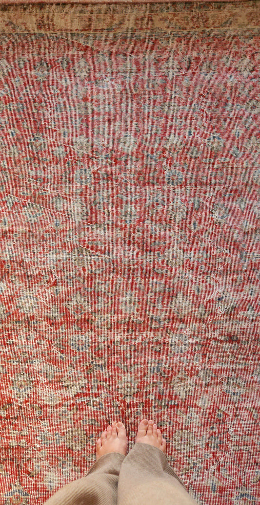 softly timeworn vintage rug with beautifully faded floral, red and muted stone tones. 